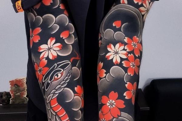 Japanese leg tattoo with clouds and cherry blossoms