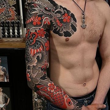 Koi fish sleeve tattoo with red flower details