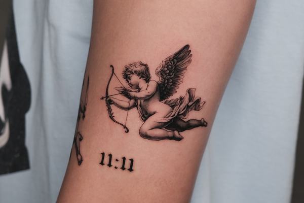 Cupid angel tattoo with bow and numbers