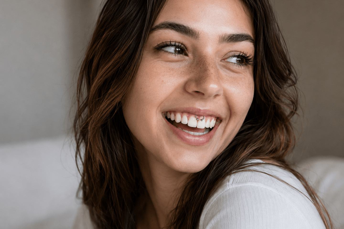 Woman with a subtle smiley piercing in a natural portrait