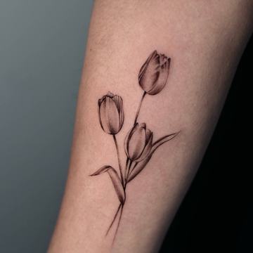 Black and grey tulip tattoo with three flowers