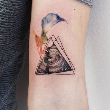 Triangle tattoo with wave and feather accents