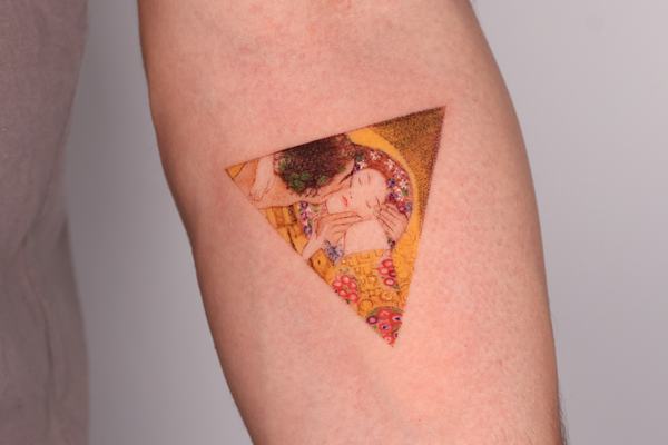 Color triangle tattoo with artistic image inside