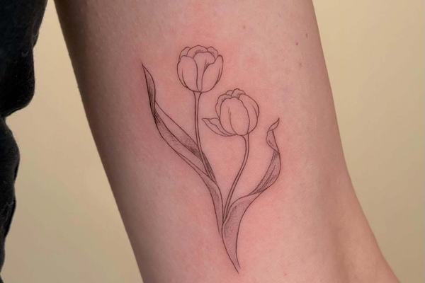 Two tulips tattoo in fine line style