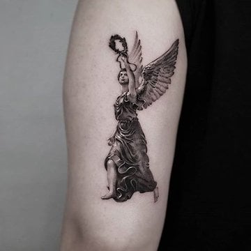 Winged angel tattoo with symbolic details
