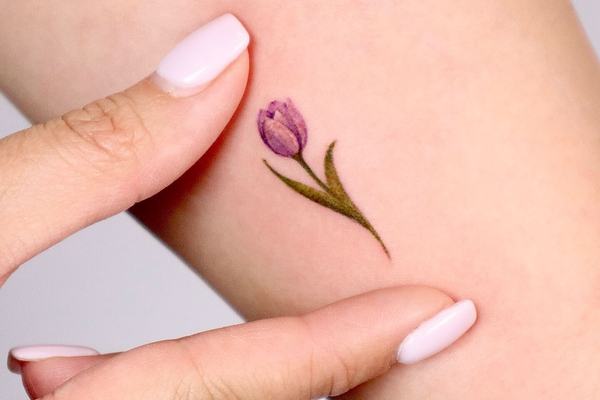 Tiny purple tulip tattoo with soft color