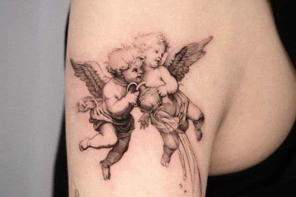 Two cherub angels tattoo on the arm